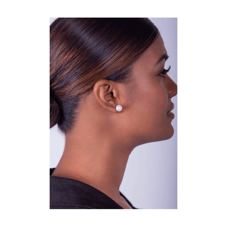 White Pearl Stud Earrings on woman